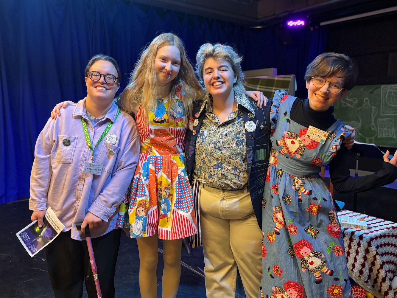 Four people posing for a group photo.